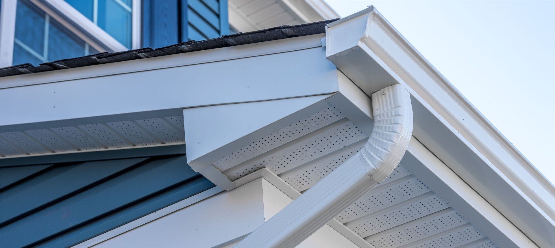 Soft washing the siding of a two-story home